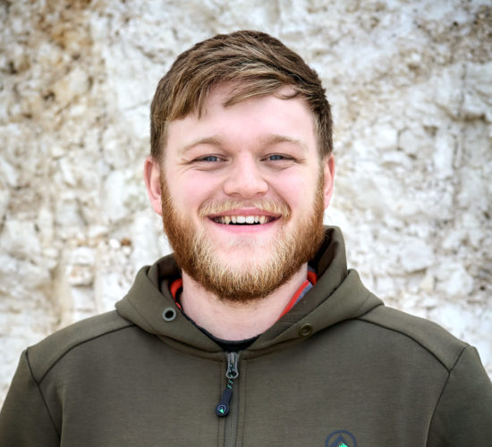 Vineyard apprentice Will in front of a wall of chalk